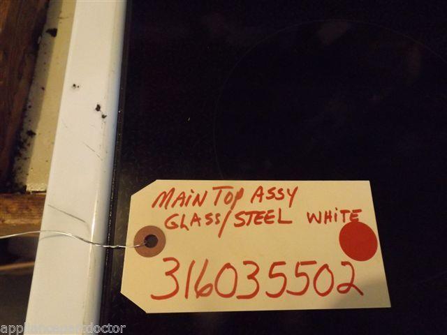 FRIGIDAIRE STOVE 316035502 MAIN TOP ASSY. GLASS/STEEL WHITE USED FRIGIDAIRE STOVE 316035502 MAIN TOP ASSY. GLASS/STEEL WHITE USED